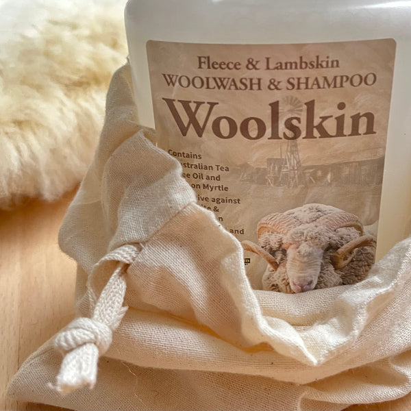 Woolskin Wool Wash in a fabric pouch with sheep illustration and natural ingredients listed.