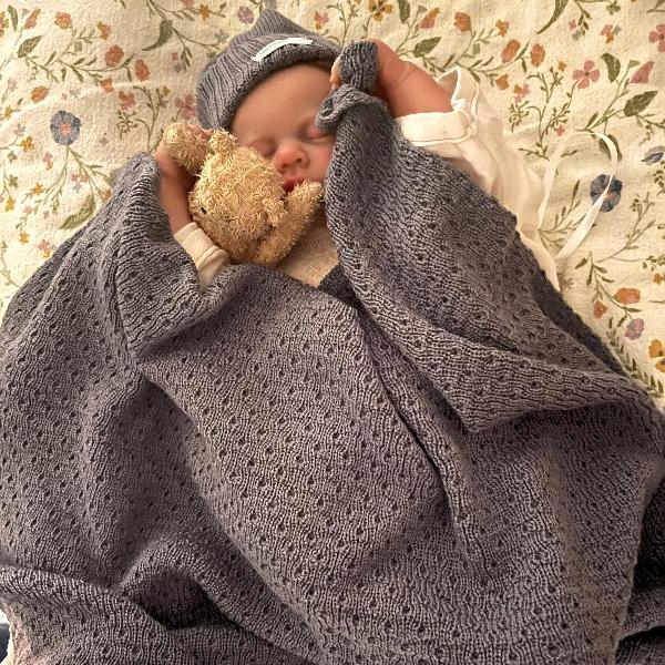 Baby asleep in dusky blue merino wrap and beanie