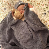 Baby asleep on dusky blue merino wrap