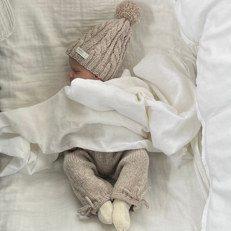 Baby asleep wearing oatmeal premature pants