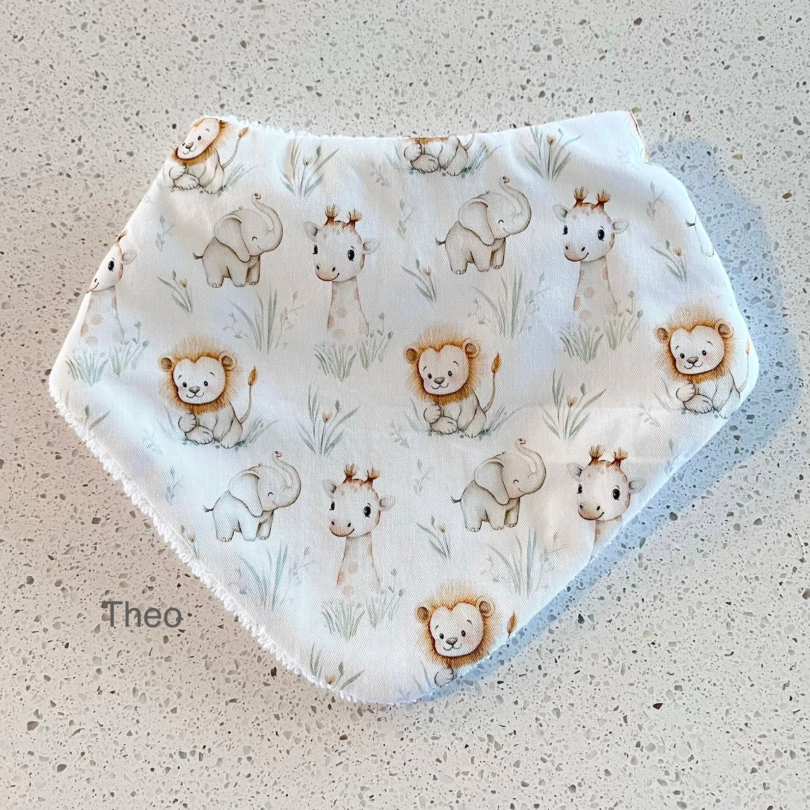Baby bib with animal pattern on a textured surface