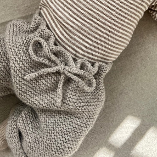 Baby girl wearing oatmeal chunky knit pants