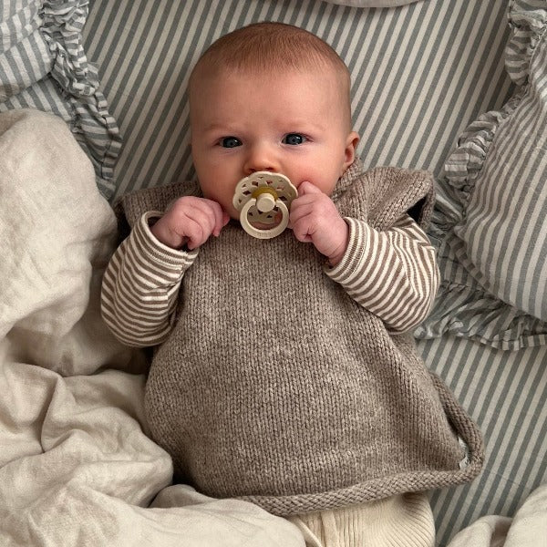 Baby girl wearing oatmeal roll neck vest