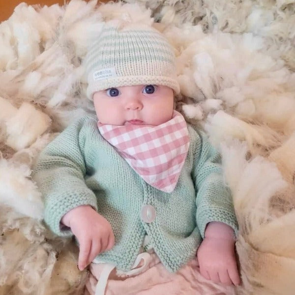 Baby in her mint cardigan and beanie set