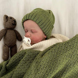 Baby in moss wrap and beanie