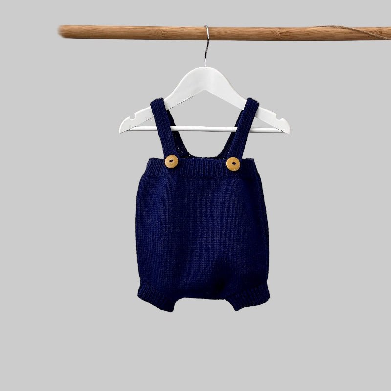 Baby romper in navy on hanger