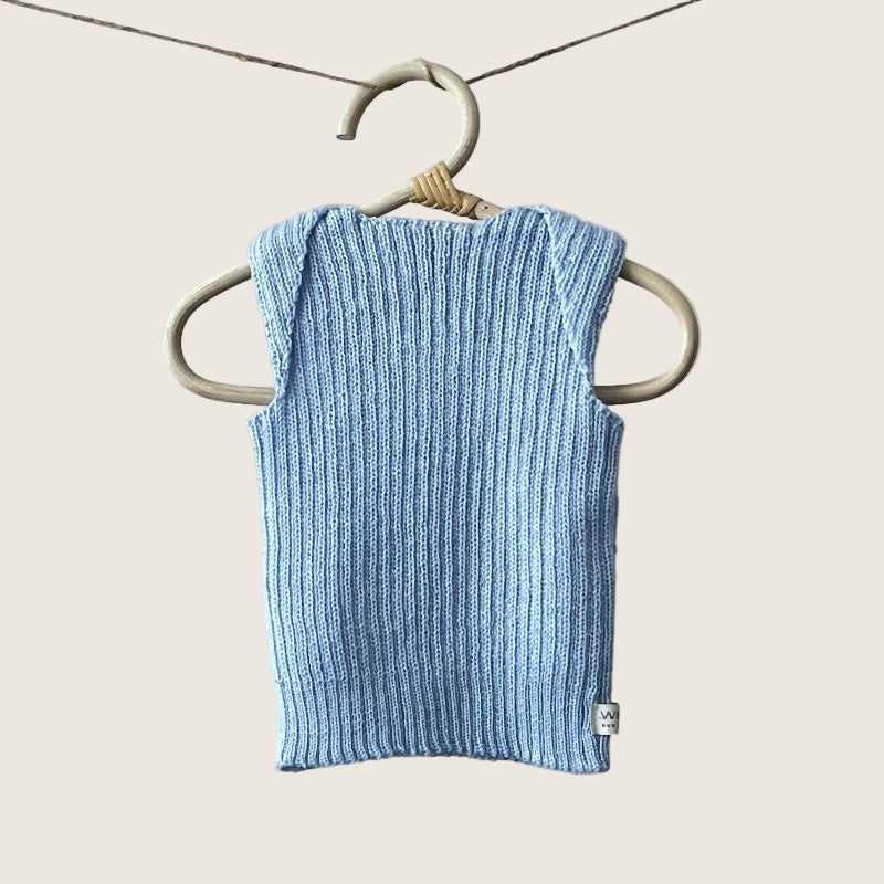 Blue ribbed baby singlet hanging on a wooden hanger against a plain background