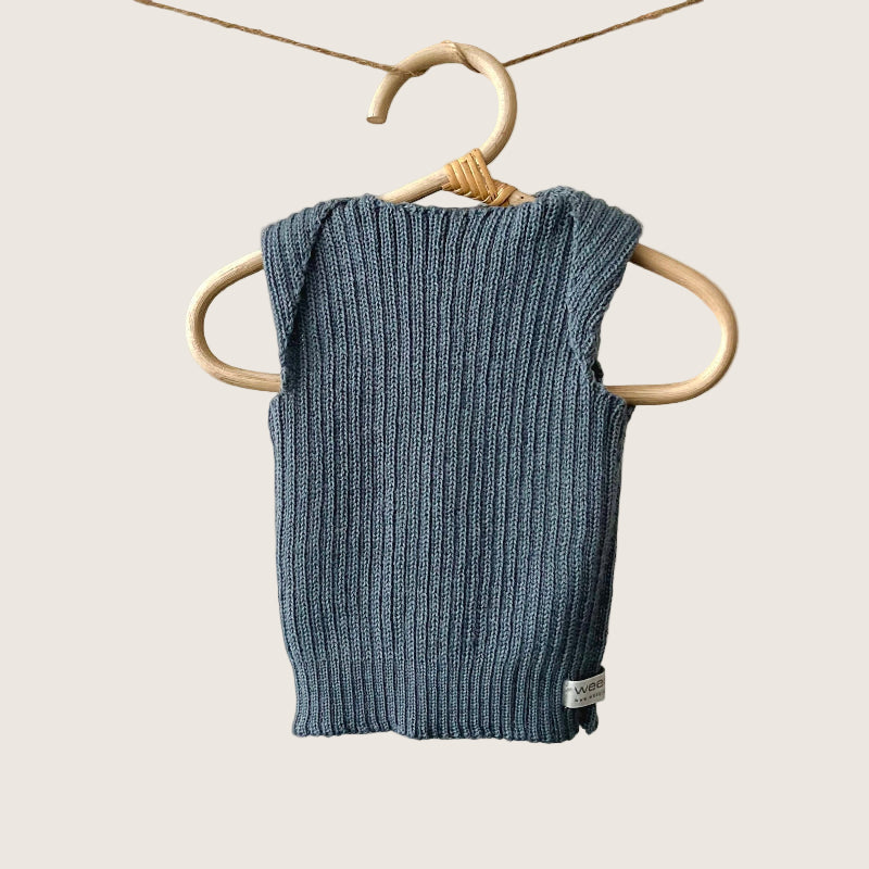 Dusky blue ribbed baby singlet hanging on a wooden hanger against a plain background