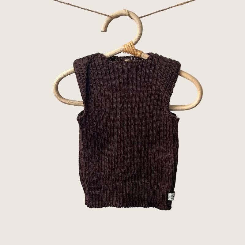 Brown ribbed baby singlet on a wooden hanger against a gray background