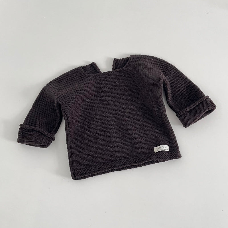 Chocolate knitted baby slouchy sweater on a white background