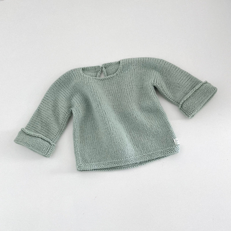 Mint knitted baby slouchy sweater on a white background