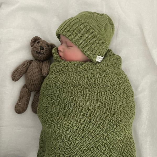 baby swaddled in moss baby wrap