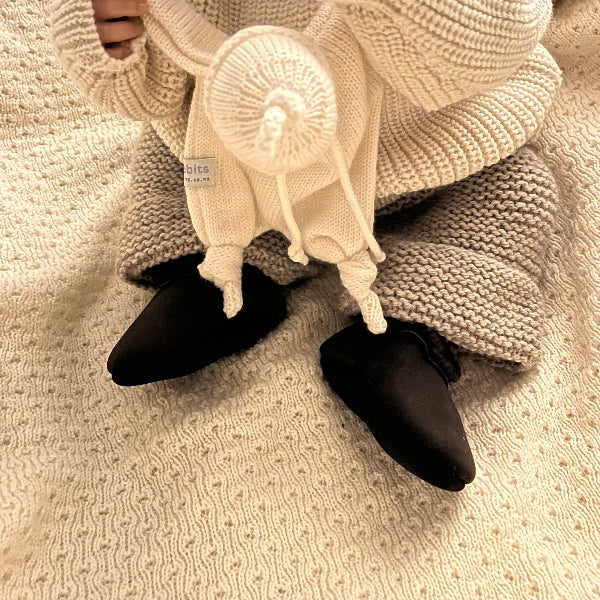 baby wearing chocolate lambskin booties