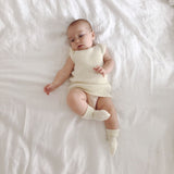 baby wearing merino vest and socks in ivory