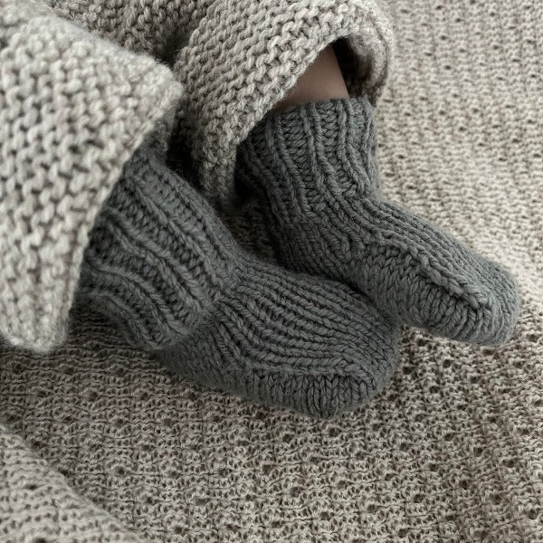 Baby wearing mushroom merino socks