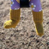 Baby wearing mustard double knit socks