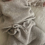 Baby wearing oatmeal chunky knit pants