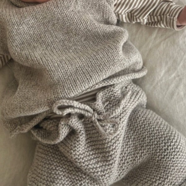Baby wearing oatmeal chunky knit pants