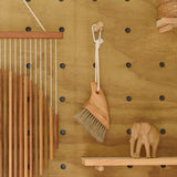 Beach brush hanging on peg board