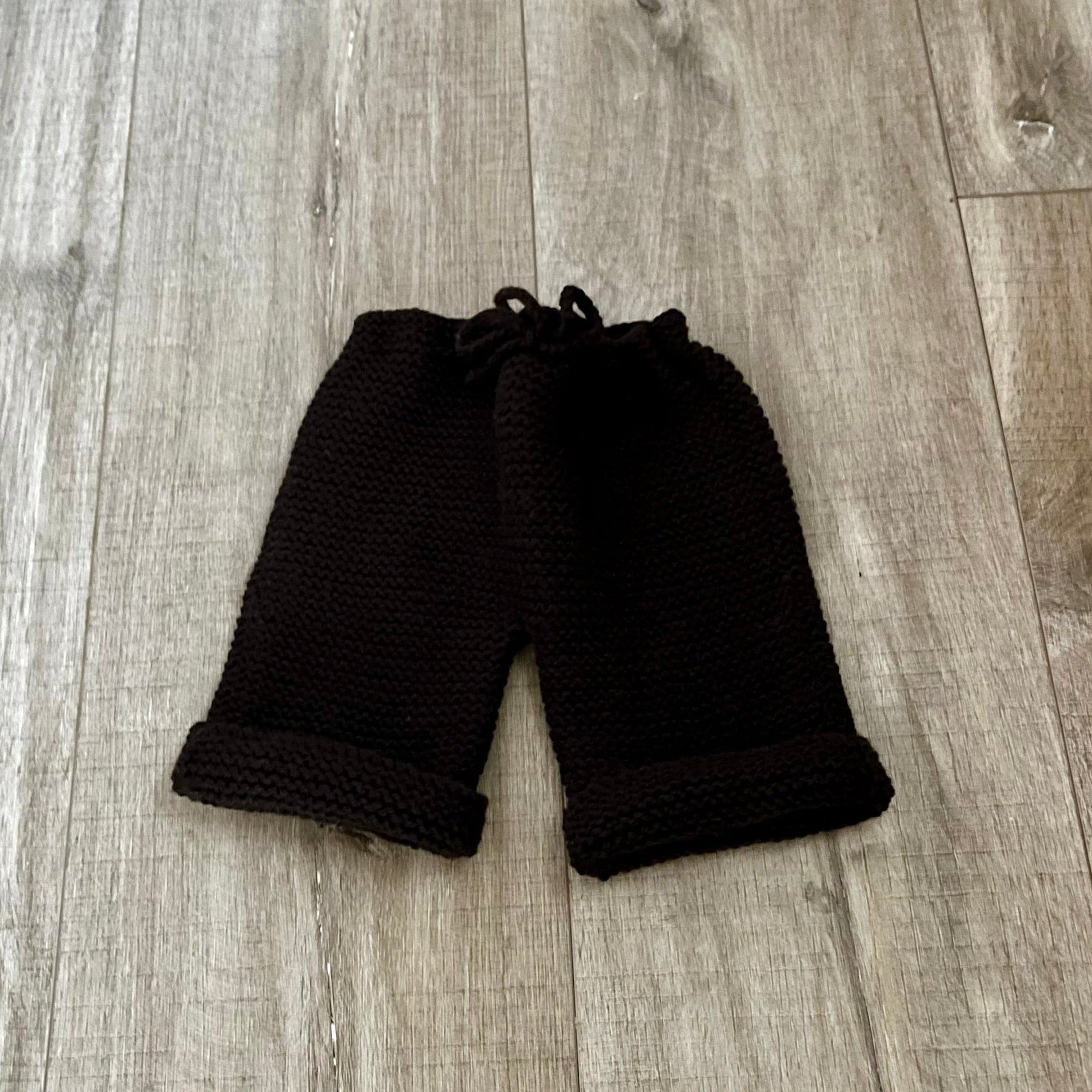 chocolate baby pants on a wooden floor