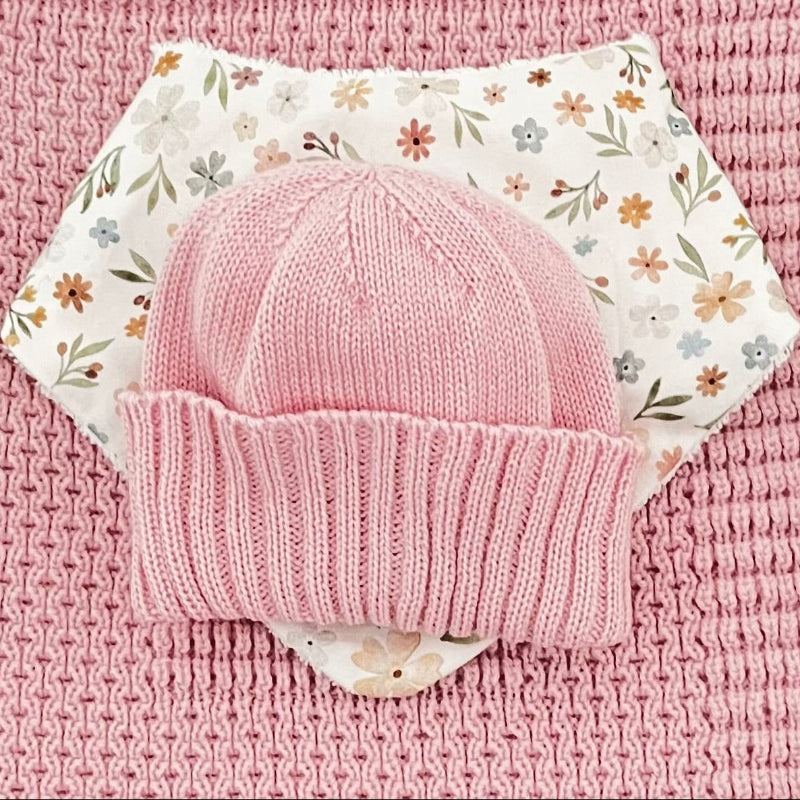 close up of blossom pink pram blanket newborn beanie dribble bib