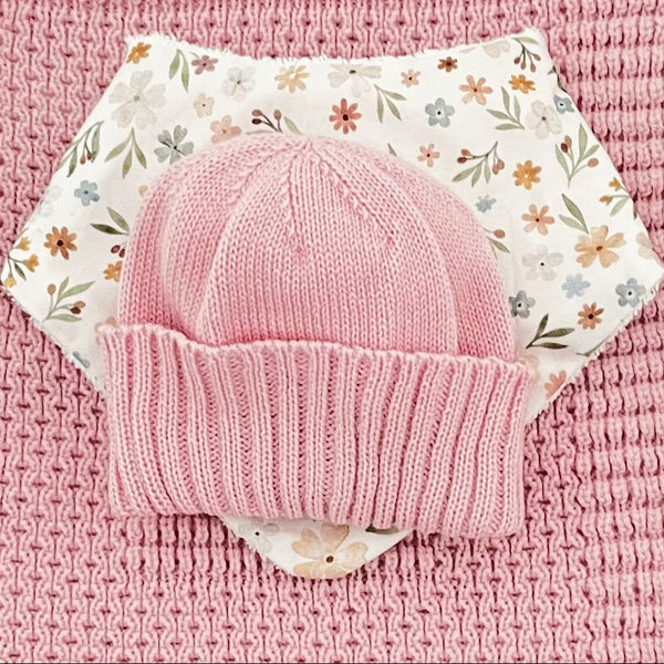 close up of blossom pink pram blanket newborn beanie dribble bib