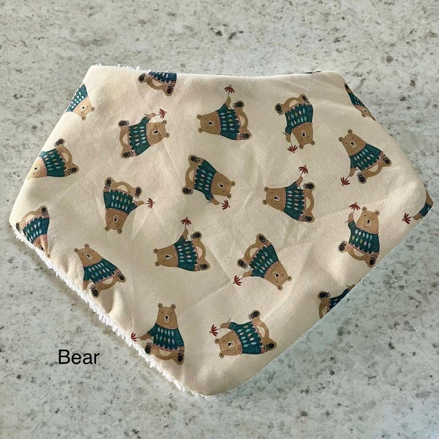 dribble bib with bear pattern on a textured surface