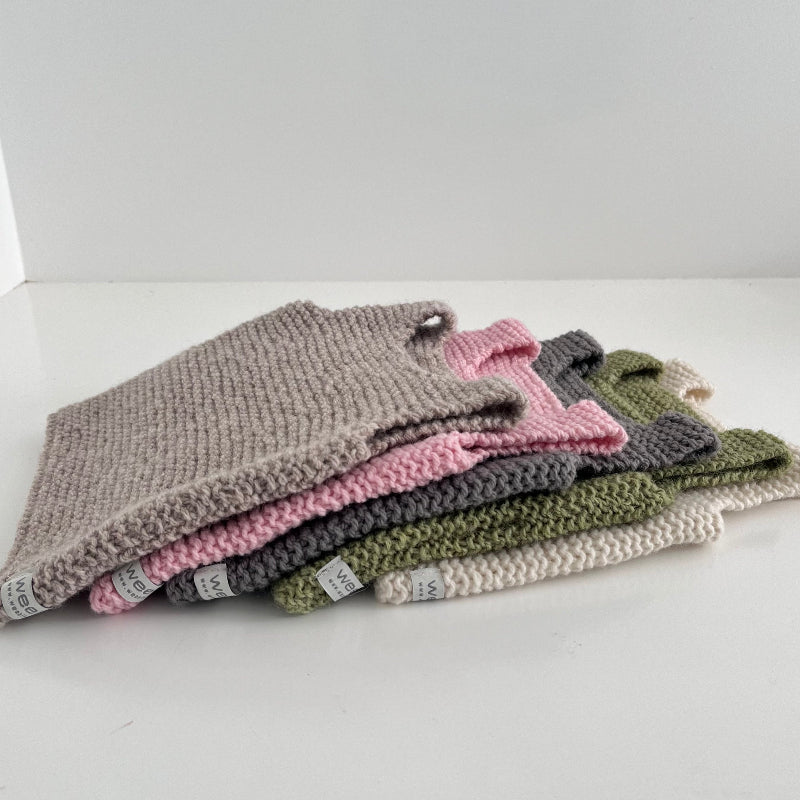 Flat lay of five baby tank tops