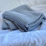 Folded misty blue merino cot blanket nz made