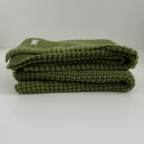 folded moss merino cot blanket nz made
