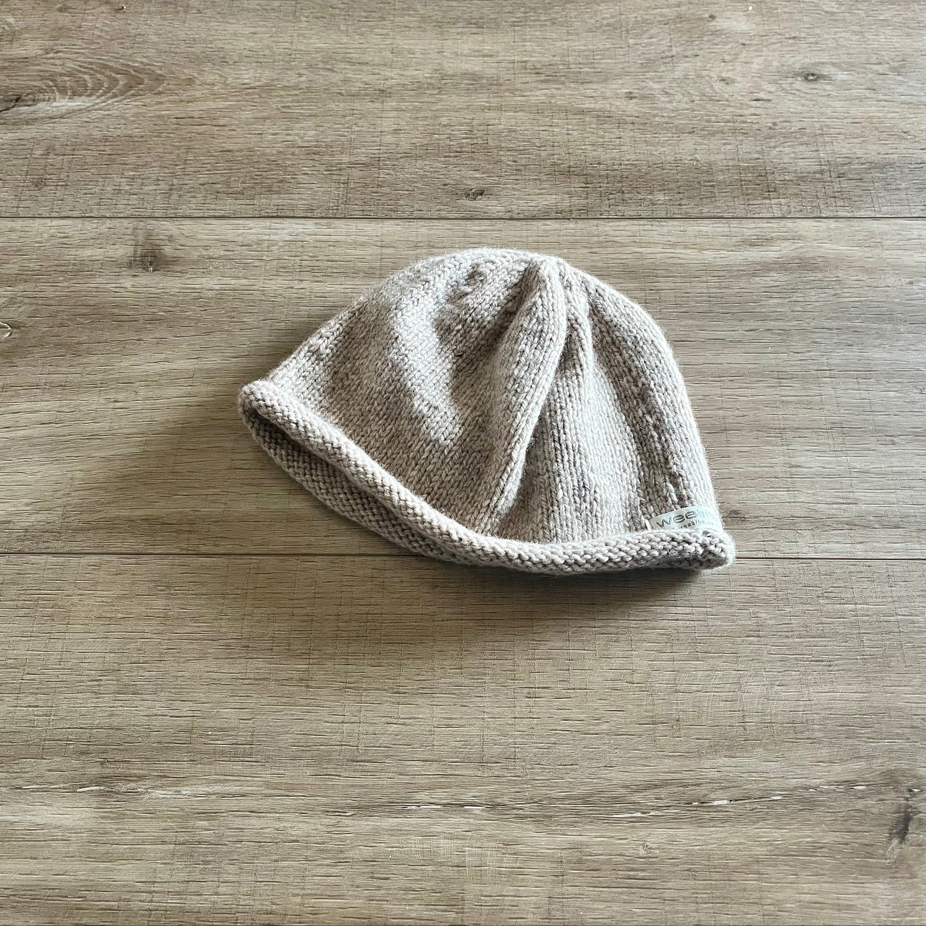 Knitted beanie on a wooden surface