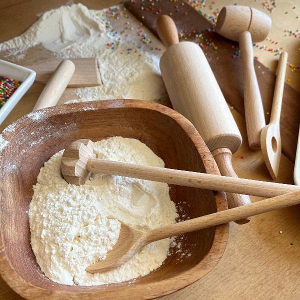 Kids playing with toy wooden cooking set