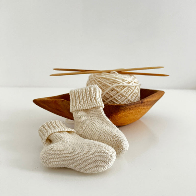 Knitted baby socks in natural