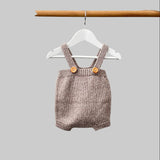 Baby romper in oatmeal on hanger