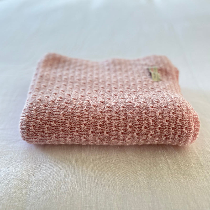 Blossom pink baby wrap on a light-colored surface