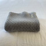 Misty blue baby wrap on a light-colored surface