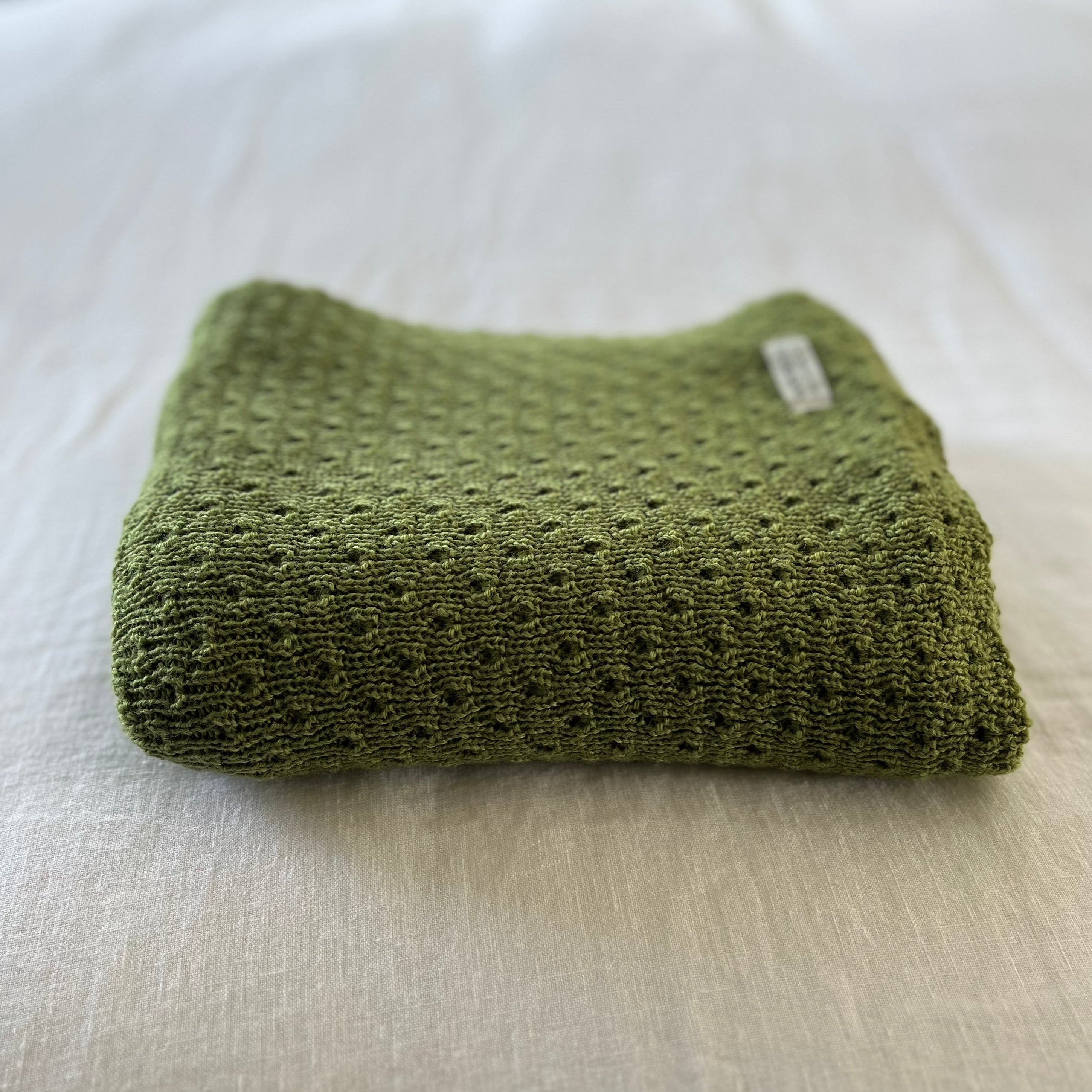 moss textured baby wrap on a light-colored surface