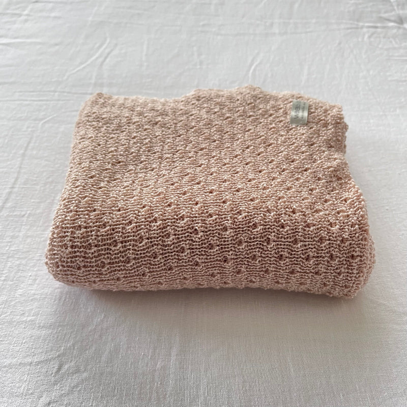warm sandstone baby wrap on a light-colored surface