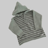 Mint and mushroom striped baby hoodie on a white surface