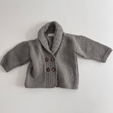 Mushroom knitted baby George jacket with buttons on a light grey background