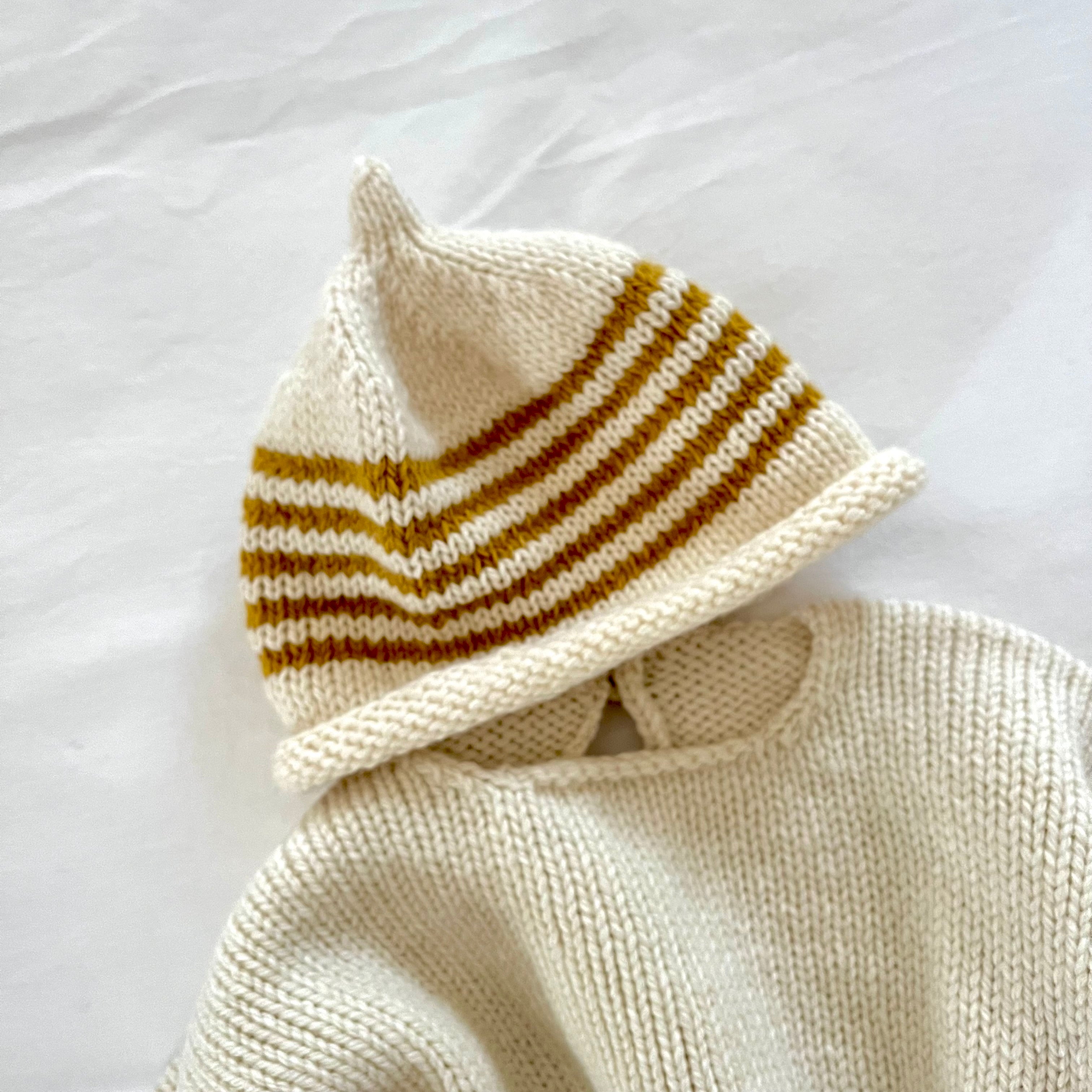 Knitted baby hat with striped pattern on a white background