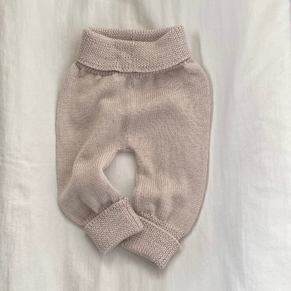 Knitted baby pants on a light background