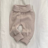 Knitted baby pants on a light background