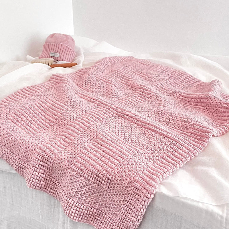 Pattern detail of blossom pink pram blanket with newborn beanie