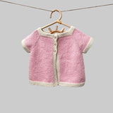 Chloe cardigan in pink with natural trim on hanger