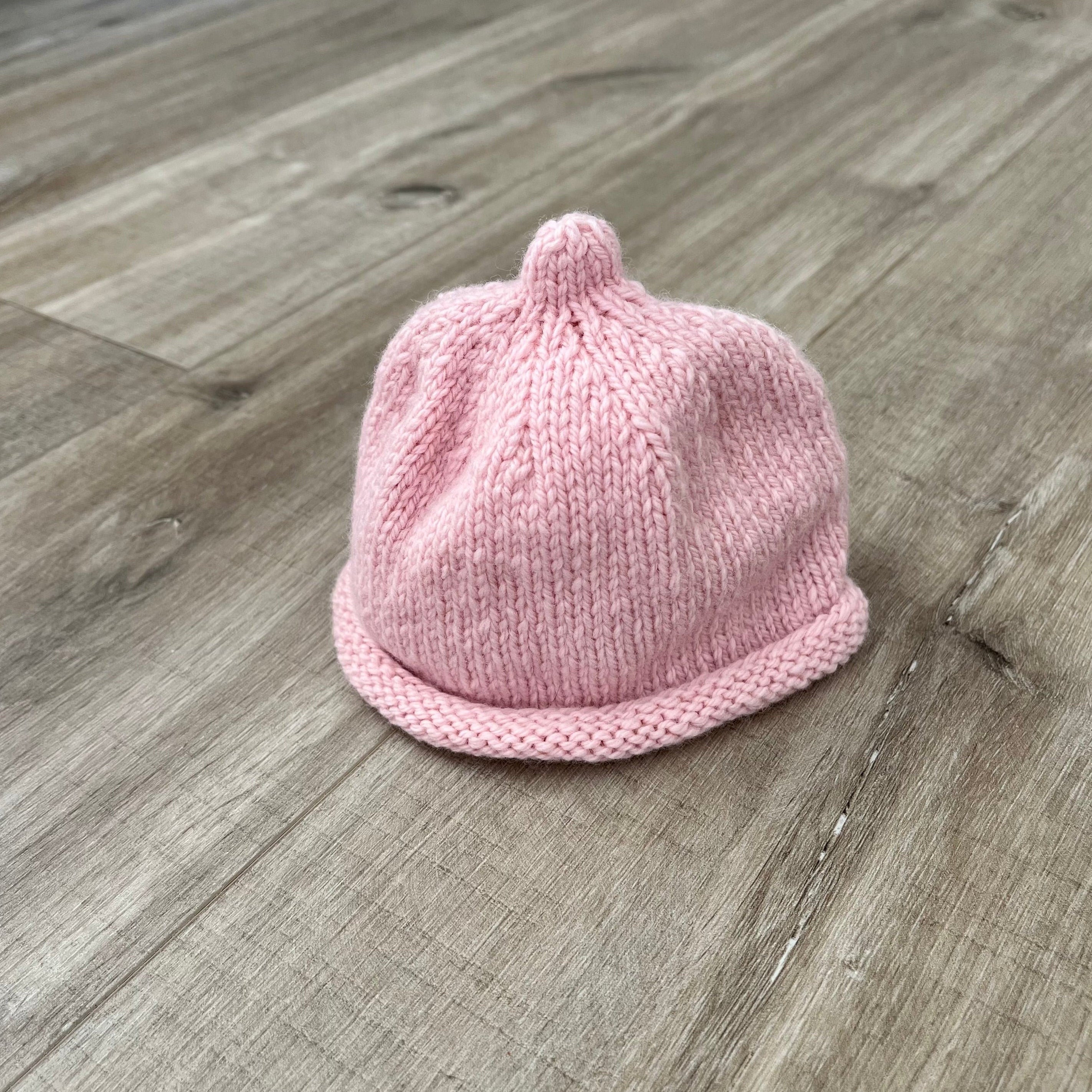 Baby-pixie-point-beanie-pink-colour-on-wooden-surface