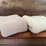 sand and natural buggy blankets on shelf