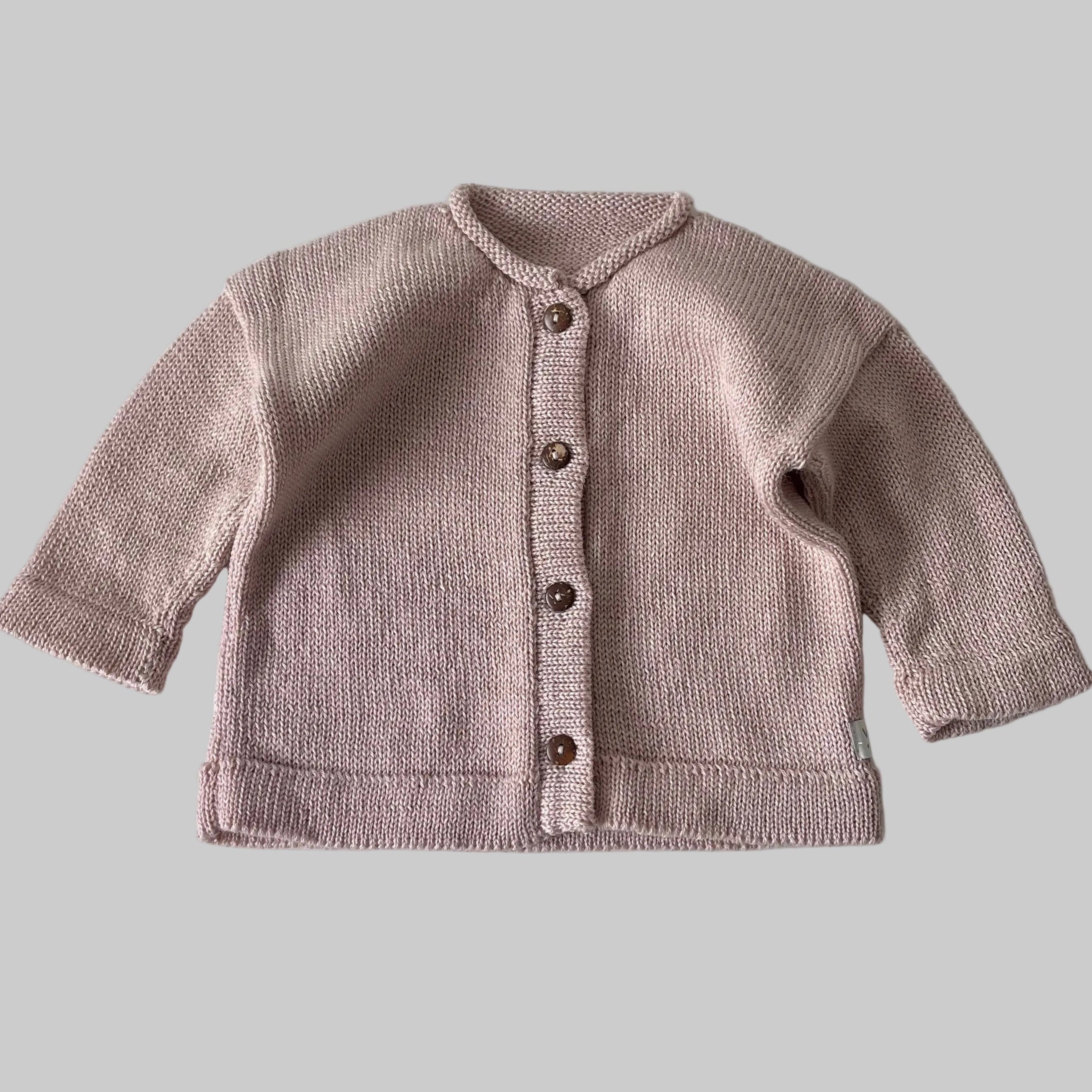 Knitted cardigan with buttons on a light gray background