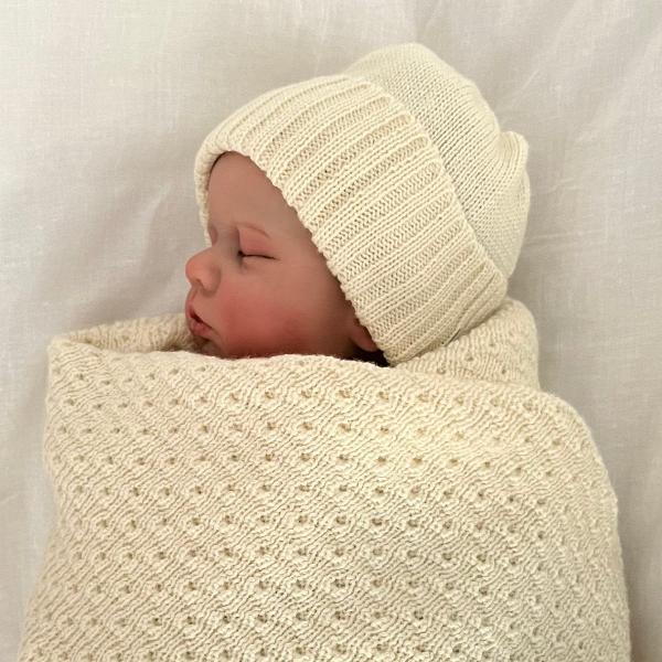 Sleeping baby in natural merino wrap and beanie