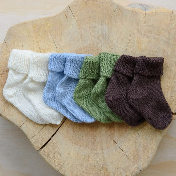 Stack of coloured merino baby socks